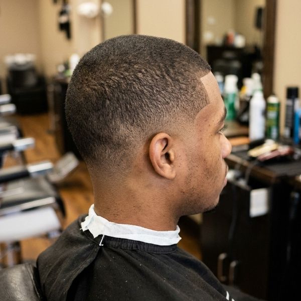 Low taper fade with a buzz cut
